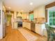 Well-lit kitchen with modern appliances, granite countertops, and traditional cabinetry at 7356 Terrace Dr, Charlotte, NC 28211