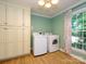 Spacious laundry room features modern washer and dryer appliances and ample cabinetry at 7356 Terrace Dr, Charlotte, NC 28211