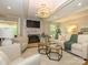 Comfortable living room featuring a fireplace, white sofas, and bright lighting at 7356 Terrace Dr, Charlotte, NC 28211