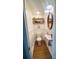 Charming powder room with hardwood floors, shelving, and decorative mirror at 7356 Terrace Dr, Charlotte, NC 28211
