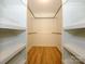 Empty walk-in closet offers customizable shelving and wooden floors at 7356 Terrace Dr, Charlotte, NC 28211