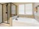 Spa-like bathroom with a soaking tub and enclosed glass shower at 85017 Newloch Ct, Lancaster, SC 29720