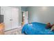 Charming bedroom with blue accents, closet, light gray walls, and adjacent doorway at 85017 Newloch Ct, Lancaster, SC 29720