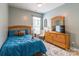 Cozy bedroom featuring a plush bed, wood furniture, and a light blue color scheme at 85017 Newloch Ct, Lancaster, SC 29720
