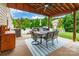 Outdoor covered patio with ceiling fan, table set, grill and view of backyard at 85017 Newloch Ct, Lancaster, SC 29720