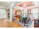 Open-concept dining room with hardwood floors, a view of the living room, and elegant décor at 85017 Newloch Ct, Lancaster, SC 29720