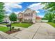 Inviting two-story home with a well-manicured lawn, charming shutters, and an attached two-car garage at 85017 Newloch Ct, Lancaster, SC 29720