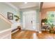 Bright foyer with hardwood floors, a decorative bench, and a view of the front door and staircase at 85017 Newloch Ct, Lancaster, SC 29720