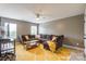 Spacious living room with yellow rug, comfy couch, fan, and plenty of light at 85017 Newloch Ct, Lancaster, SC 29720