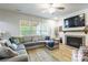 Cozy living room with fireplace, ceiling fan, a large sofa and lots of natural light at 85017 Newloch Ct, Lancaster, SC 29720