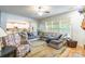 Inviting living room featuring a large sectional sofa, hardwood floors and access to the kitchen at 85017 Newloch Ct, Lancaster, SC 29720