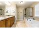 Main bathroom with double vanity, soaking tub and tiled shower at 85017 Newloch Ct, Lancaster, SC 29720