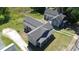 Aerial view of a cozy home with a long driveway and gray roof at 921 W 1St St, Lowell, NC 28098