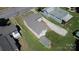 Aerial view of the home with its driveway, back yard, and outbuilding at 921 W 1St St, Lowell, NC 28098