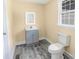 This bathroom features a sink with cabinet, toilet and window at 921 W 1St St, Lowell, NC 28098