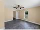 Bedroom featuring a ceiling fan, neutral paint, gray flooring and a window at 921 W 1St St, Lowell, NC 28098