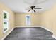 Cozy bedroom featuring neutral walls, gray flooring, and a bright window at 921 W 1St St, Lowell, NC 28098