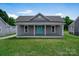 Charming single-story home featuring a covered front porch and well-maintained lawn at 921 W 1St St, Lowell, NC 28098