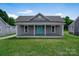 Charming home with a large, well-manicured lawn and a welcoming covered porch at 921 W 1St St, Lowell, NC 28098