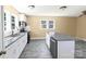 Modern kitchen featuring white cabinets, stainless appliances, and a kitchen island at 921 W 1St St, Lowell, NC 28098