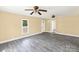 Spacious living room featuring modern gray floors, neutral walls, and ample natural light at 921 W 1St St, Lowell, NC 28098
