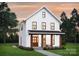 Charming two-story white farmhouse-style home with inviting front porch and manicured lawn at 0000 Trull Hinson Rd # 2, Wingate, NC 28174