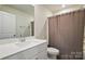 Bathroom featuring a shower/tub combo, and a vanity with solid surface countertop and a framed mirror at 1015 Maltby St, Charlotte, NC 28217