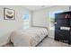 Bedroom with neutral tones, carpet, large window with blinds, with built in shelving and display cabinet at 1015 Maltby St, Charlotte, NC 28217