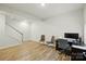Bonus room with laminate floors, neutral tones, a desk and a staircase to the side at 1015 Maltby St, Charlotte, NC 28217