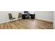 Bonus room featuring laminate floors, neutral tones, a desk and lots of natural light at 1015 Maltby St, Charlotte, NC 28217