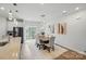 Elegant dining area with a modern table, upholstered chairs, and access to the outdoor balcony from kitchen at 1015 Maltby St, Charlotte, NC 28217