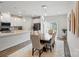 Bright dining area features modern pendant lighting and flows into the kitchen with stainless steel appliances at 1015 Maltby St, Charlotte, NC 28217