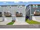 Rear view of a townhouse featuring private balconies and attached garage at 1015 Maltby St, Charlotte, NC 28217