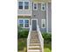 Inviting townhome entrance with well-lit walkway and modern design elements at 1015 Maltby St, Charlotte, NC 28217