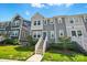 Stylish townhome with well-maintained lawn and inviting entrance, showcasing modern design at 1015 Maltby St, Charlotte, NC 28217