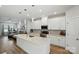Modern kitchen with white cabinets, a large island, stainless steel appliances, and open to the living area at 1015 Maltby St, Charlotte, NC 28217
