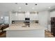 Modern white kitchen with a large island, pendant lighting, and ample cabinet space at 1015 Maltby St, Charlotte, NC 28217