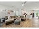 Spacious open-concept living room with a large sectional, hardwood floors, and a view of the kitchen at 1015 Maltby St, Charlotte, NC 28217
