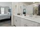 Bathroom featuring dual sinks, a large mirror, and a view into the main bedroom at 1015 Maltby St, Charlotte, NC 28217