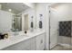 Bright bathroom with dual sinks, quartz countertops, and a glass-enclosed shower at 1015 Maltby St, Charlotte, NC 28217