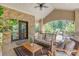 Covered back porch with brick accents, ample seating, ceiling fan and view of lush greenery at 102 Antioch Plantation Dr # 18, Matthews, NC 28104