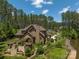 Backyard featuring mature trees, an outdoor kitchen, and an outdoor living area, all near a lush lawn at 102 Antioch Plantation Dr # 18, Matthews, NC 28104