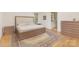 Bright bedroom featuring a minimalist bed frame and wood flooring at 102 Antioch Plantation Dr # 18, Matthews, NC 28104