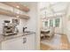 Butler pantry with granite countertops, sink, and open shelving at 102 Antioch Plantation Dr # 18, Matthews, NC 28104