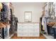 Spacious walk-in closet with custom storage, and a center dresser at 102 Antioch Plantation Dr # 18, Matthews, NC 28104