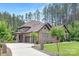 Traditional brick home with manicured landscaping, a curving driveway and attached garages at 102 Antioch Plantation Dr # 18, Matthews, NC 28104
