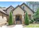 Beautifully crafted home entrance features brick façade, manicured landscaping, and inviting black front door at 102 Antioch Plantation Dr # 18, Matthews, NC 28104