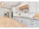 Bright kitchen featuring white cabinets, granite countertops, and a wood range hood at 102 Antioch Plantation Dr # 18, Matthews, NC 28104