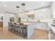 Modern kitchen with bar stool seating, stainless steel appliances, and pendant lighting at 102 Antioch Plantation Dr # 18, Matthews, NC 28104
