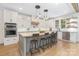 Modern, open kitchen with white cabinetry, an island with barstool seating and stainless steel appliances at 102 Antioch Plantation Dr # 18, Matthews, NC 28104